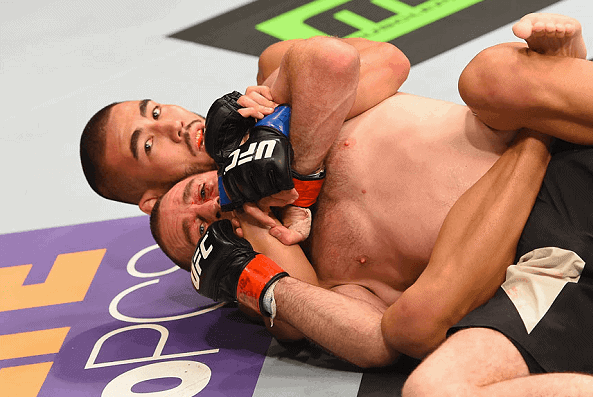 MMA Fighter Hawaiian Lewis Smolka applying a rear naked choke against irishman neil seery